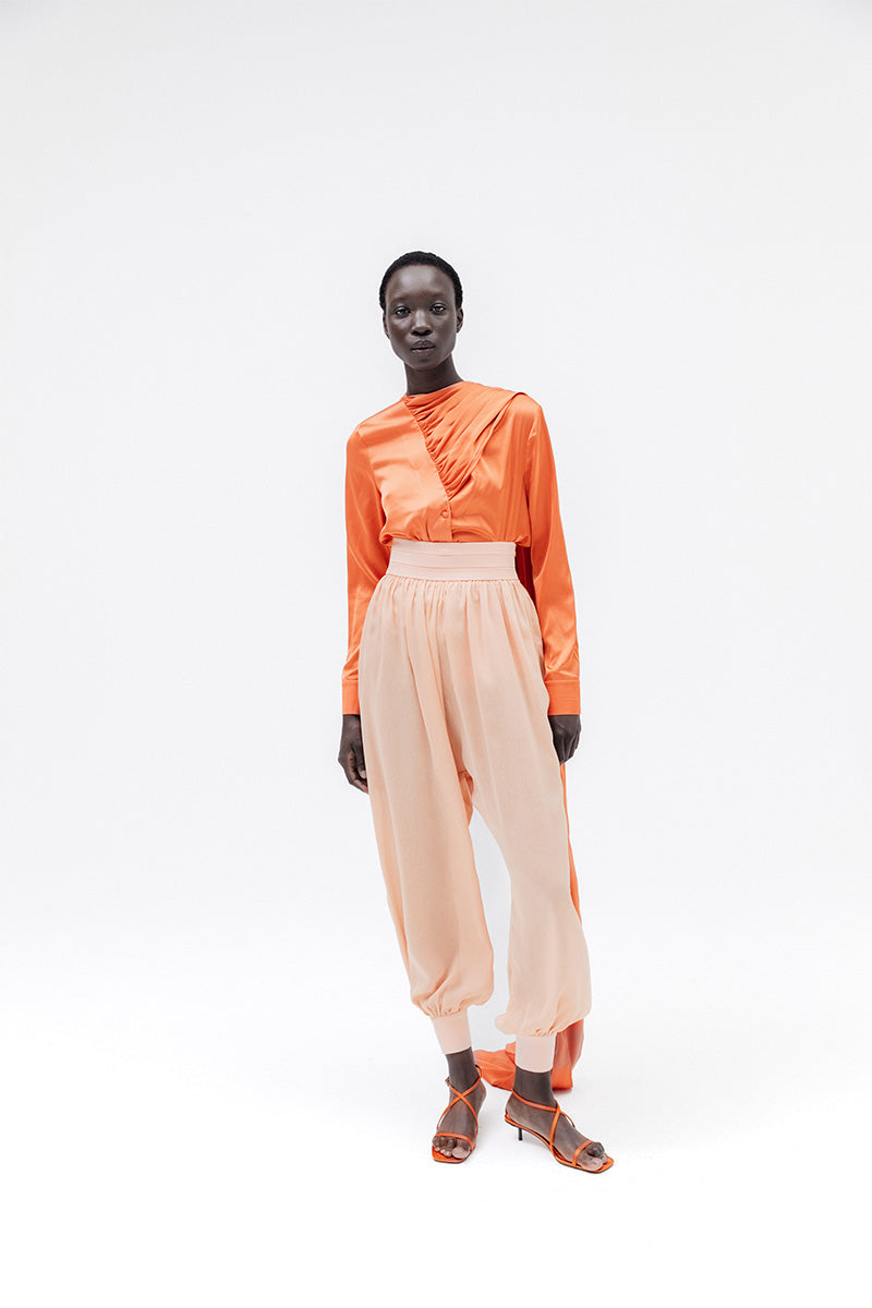 Studio NK Bloom Peach Pants, stylish women's trousers with a comfortable fit, shown in a soft peach color.