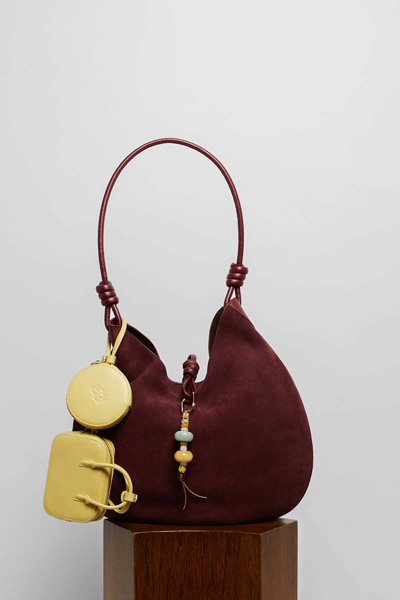 Maroon suede boho shoulder bag from Folklore The Label with a relaxed, stylish design and natural leather strap.