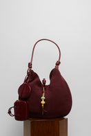 Maroon suede boho shoulder bag by Folklore The Label with relaxed, stylish design and adjustable strap.