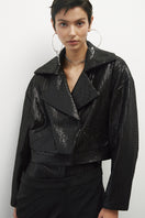 Black biker jacket with mini paillettes from JC Pajares, featuring a sleek design and metallic embellishments.