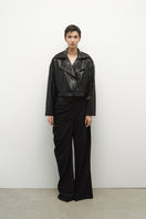 JC Pajares biker jacket with mini paillettes, featuring a stylish black design and metallic embellishments.