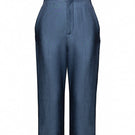 Jenny K Tran Bradford shorts in casual denim with a relaxed fit, displayed on a wooden background.