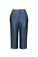 Jenny K Tran Bradford shorts in casual denim with a relaxed fit, displayed on a wooden background.
