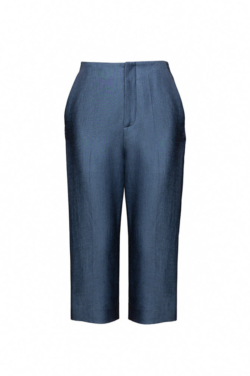 Jenny K Tran Bradford shorts in casual denim with a relaxed fit, displayed on a wooden background.