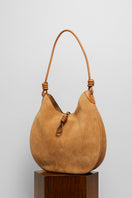 Beige suede boho shoulder bag from FolkLore The Label with a relaxed, stylish design and natural leather strap.