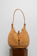 Beige suede boho shoulder bag from Folklore The Label with relaxed, stylish design and natural texture.