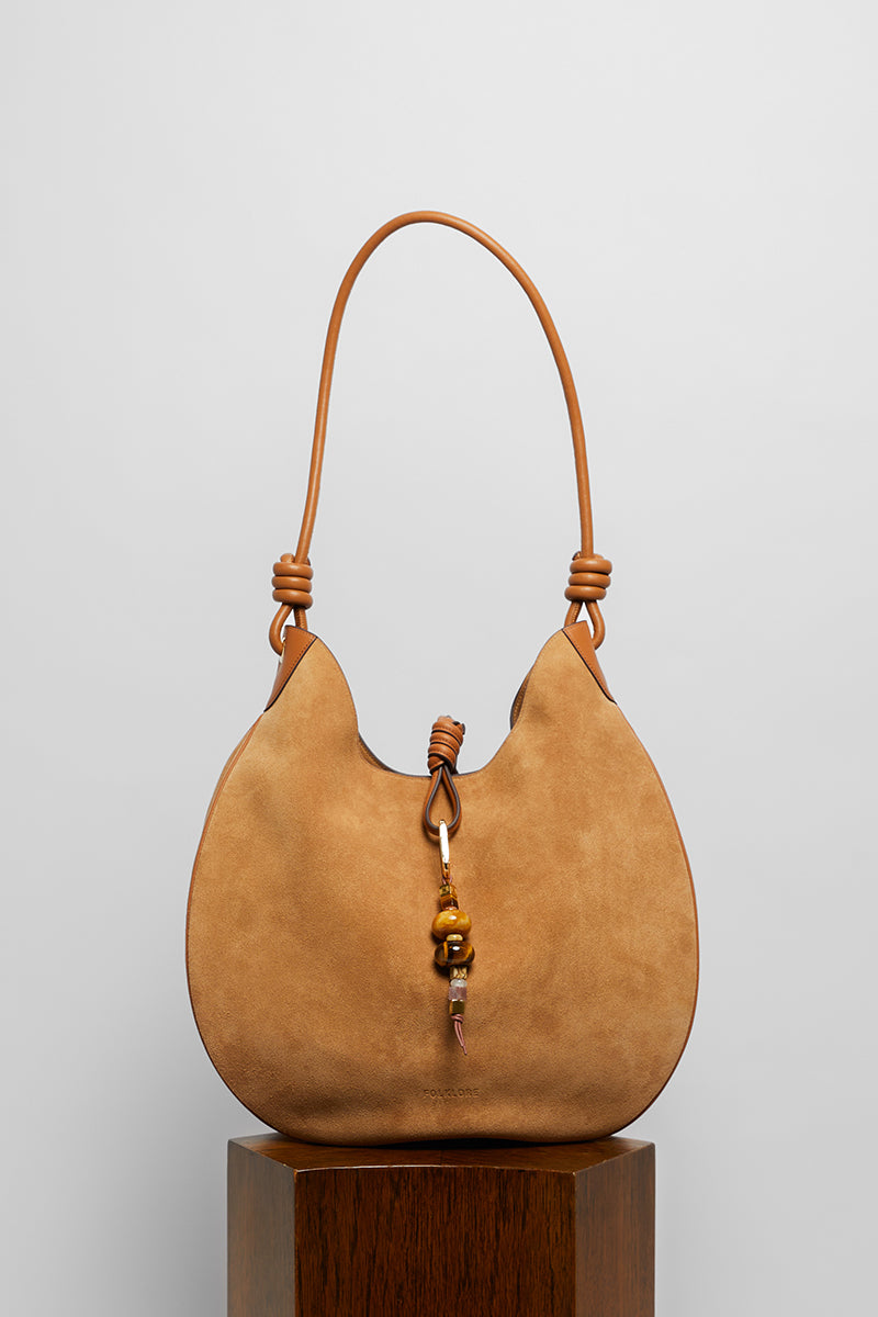Beige suede boho shoulder bag from Folklore The Label with relaxed, stylish design and natural texture.