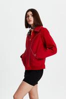 Black studded jacket from Bassigue featuring metal studs, stylish design, and a tailored fit for edgy fashion.