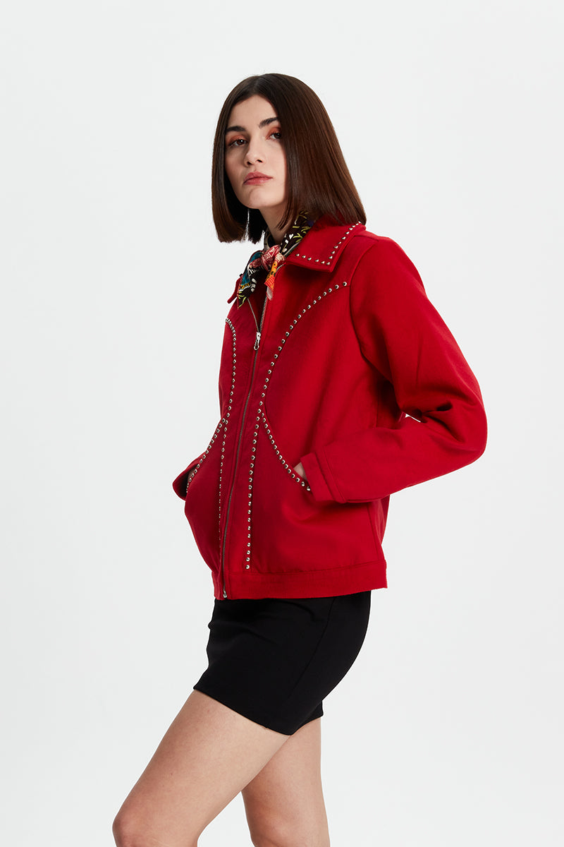 Black studded jacket from Bassigue featuring metal studs, stylish design, and a tailored fit for edgy fashion.