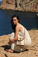 Saonara linen bucket top handle bag with a rounded shape and sturdy top handle, ideal for casual or elegant outings.