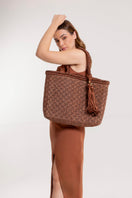 Mara Brazil Buritirana shoulder bag in brown leather with woven details and adjustable strap.