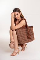 Mara Brazil Buritirana shoulder bag in brown leather with woven design, featuring a spacious interior and adjustable strap.