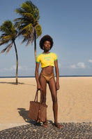 Mara Brazil buritirana shoulder bag made from natural buriti fiber with brown accents, featuring a woven textured design.