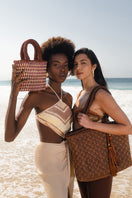 Brown Mara Brazil Vida Bag in Buriti leather, top handle design with elegant stitching and natural texture.