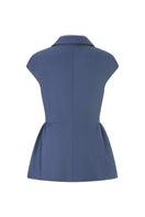 Lecia peplum top in black, featuring a fitted waist and flared hem, displayed on a hanger against a neutral background.
