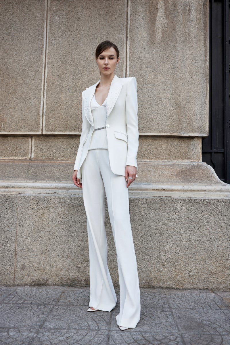Light-colored Kenya white straight wide-leg pants by Lekieu displayed on a hanger with a clean background.