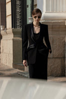 Black LEKIEU Darcey blazer jacket hanging on a wooden hanger, showcasing tailored fit and sleek style.