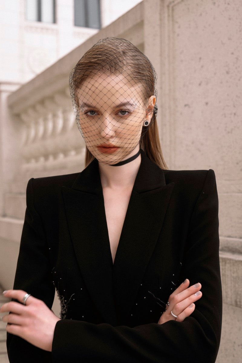 LEKIEU Cienne black blazer jacket displayed on a hanger, showcasing a tailored fit and sleek design for stylish office wear.