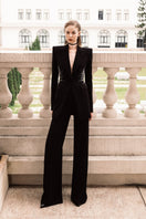 LEKIEU Martine black straight ribbed pants laid flat, showing the fitted waistband and sleek, textured fabric.