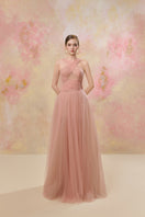 Pink LYRA gown by JOSÉPHINE, featuring elegant fabric and a flowing design, perfect for formal occasions.