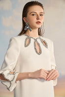 Elegant beige Adela crepe cut-out gown by 21Six, showcasing a stylish neckline and sleek silhouette.