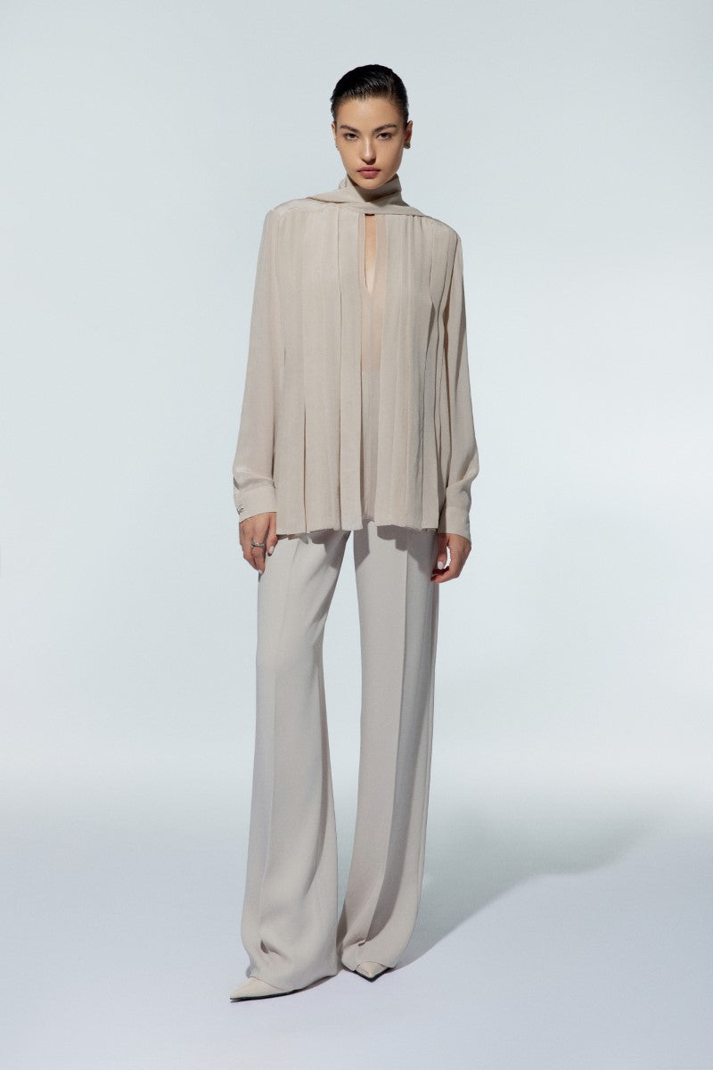 LEKIEU Kenya Cream straight wide-leg pants displayed hanging, showcasing their relaxed fit and stylish design.