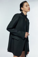 LEKIEU Stanton black blazer jacket with tailored fit and classic lapel, displayed on a hanger.