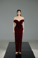 Red off-shoulder velvet floral gown by Happy Clothing, featuring a flowing design and elegant floral pattern.