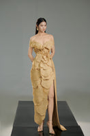 Beige off-shoulder tweed petal gown by Happy Clothing, featuring elegant design and textured fabric for formal occasions.
