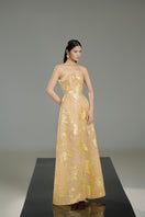 Beige strapless crystal gown by Happy Clothing featuring intricate beadwork and a flowing silhouette.