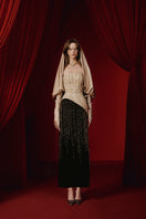 Elegant NIDALII gown by JOSÉPHINE displayed on a mannequin with flowing fabric and intricate details.