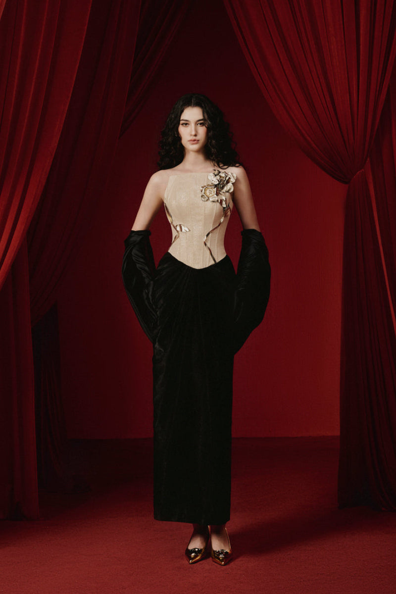 Black Joséphine Samyra gown with elegant draping and long sleeves, displayed on a mannequin.