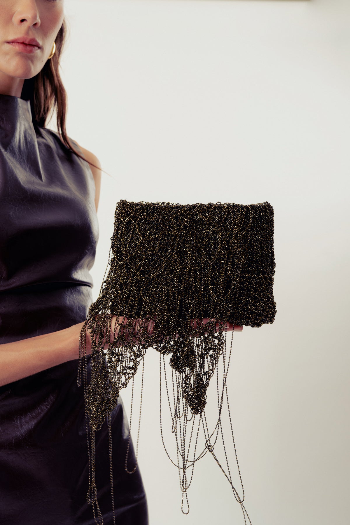 Millanne Tale Babru brown clutch bag with crochet black and gold design, stylish and compact for evening or special occasions.