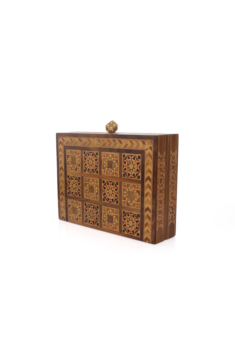Sarah's Bag backgammon clutch with mother-of-pearl dice, featuring a stylish brown leather exterior and intricate game design.