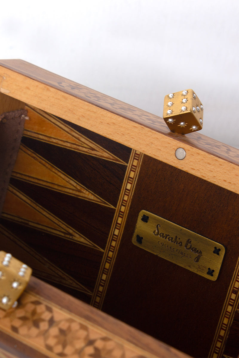 Sarah's Bag backgammon clutch with mother of pearl dice and brown leather exterior, stylish and functional accessory.