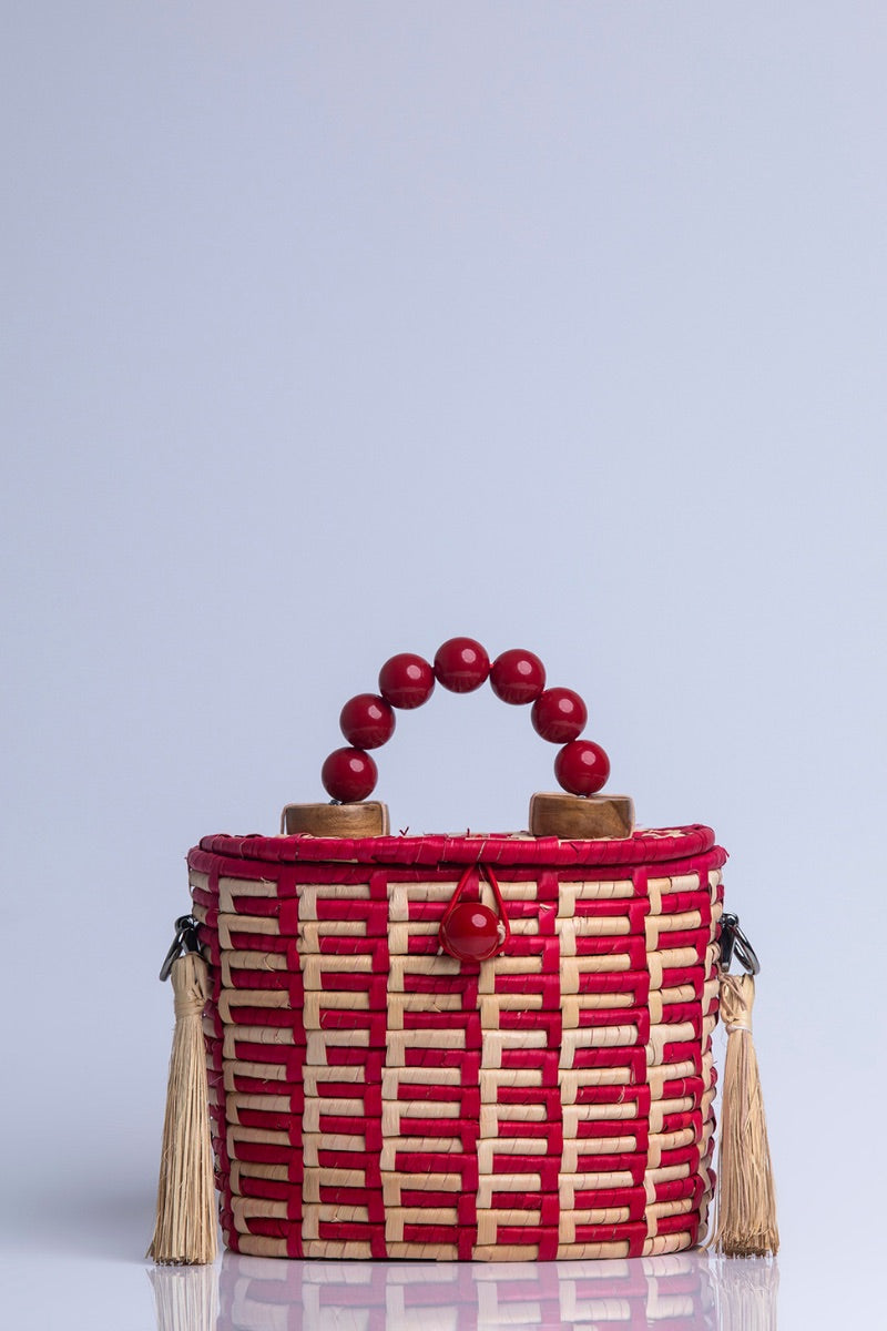 Red Catarina Mina Jirau basket top handle bag with woven design and sturdy handles, stylish and functional for everyday use.
