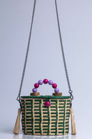 Green Catarina Mina Jirau top handle basket bag with woven design and sturdy handles.