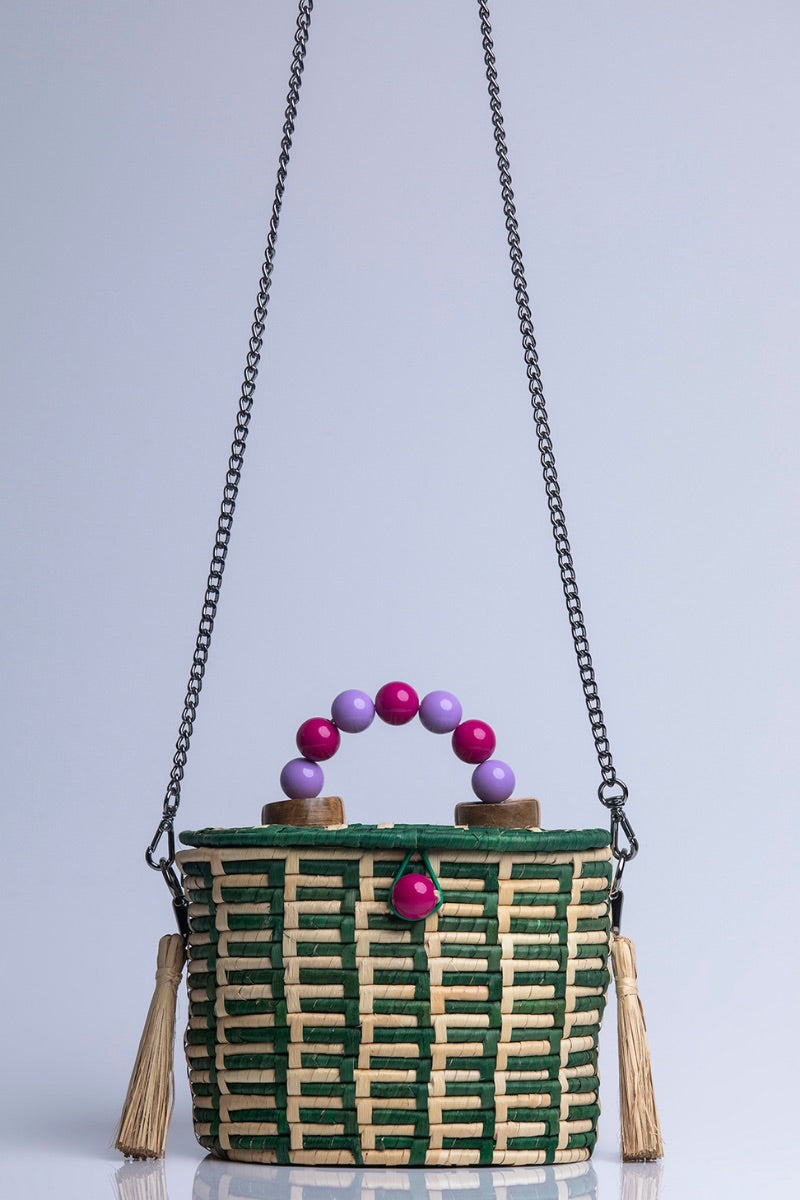 Green Catarina Mina Jirau top handle basket bag with woven design and sturdy handles.