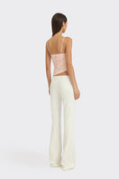 Light pink balloon draped bustier top by Stolen Stores, featuring a fitted silhouette and stylish design.