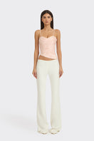 Light pink balloon-draped bustier top by Stolen Stores, featuring a fitted silhouette and stylish design.