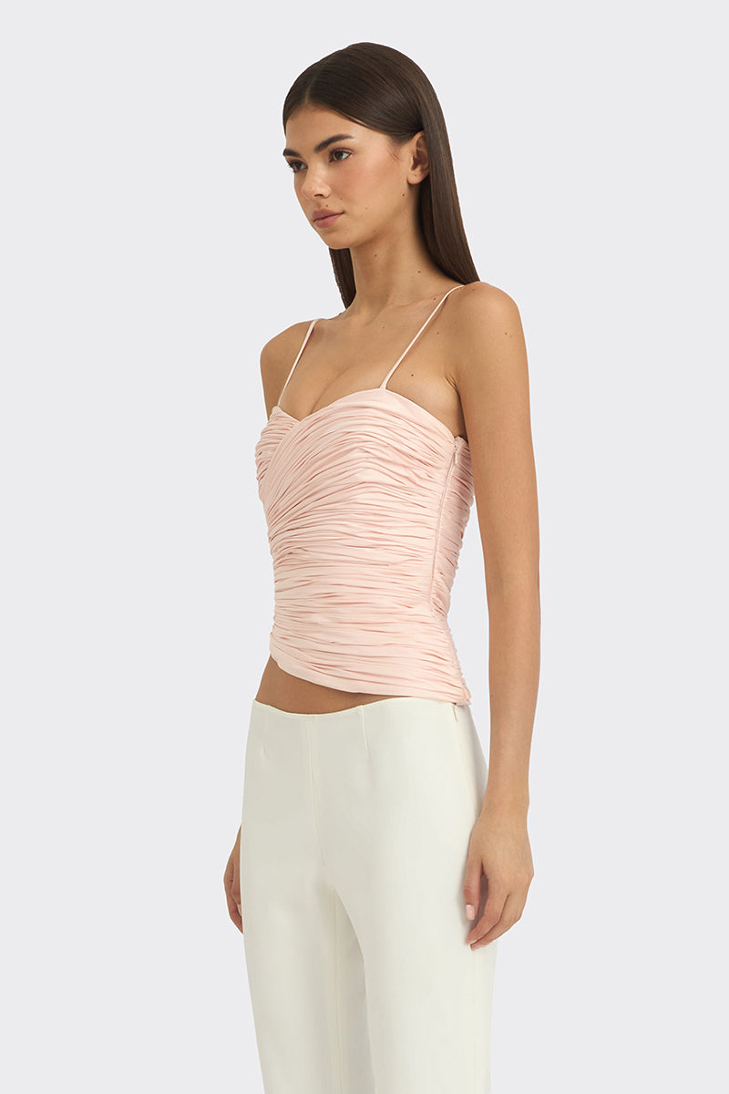 Light pink balloon-draped bustier top by Stolen Stores, featuring a fitted design with soft, flowing fabric details.