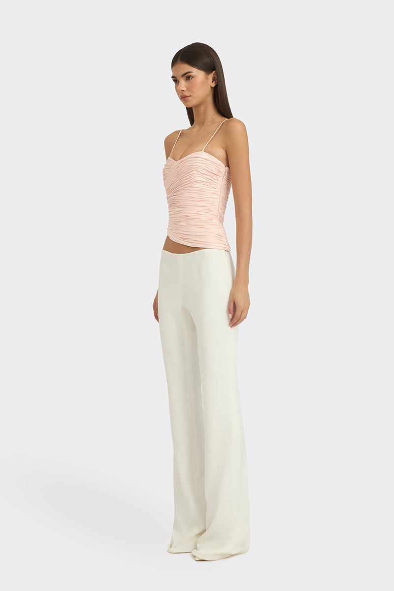 Light pink balloon-draped bustier top by Stolen Stores, featuring a structured design with soft, flowing fabric.