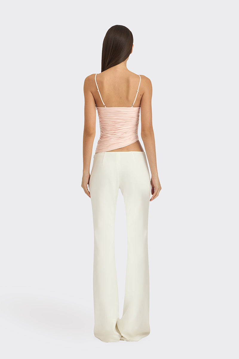 Light pink balloon-draped bustier top by Stolen Stores, featuring a fitted design and stylish draped fabric details.