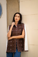 Nadya Shah BALTHAZAR Cape jacket in black, shown with wide collar and flowing fabric, stylish outerwear for cold weather.