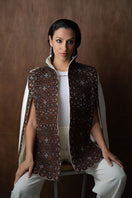 Nadya Shah Balthazar Cape jacket in dark fabric, draped style with hood, displayed on a hanger.