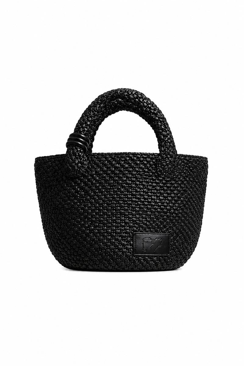Black raffia basked bag with top handle from Folklore the Label, showcasing a stylish and textured accessory for everyday use.