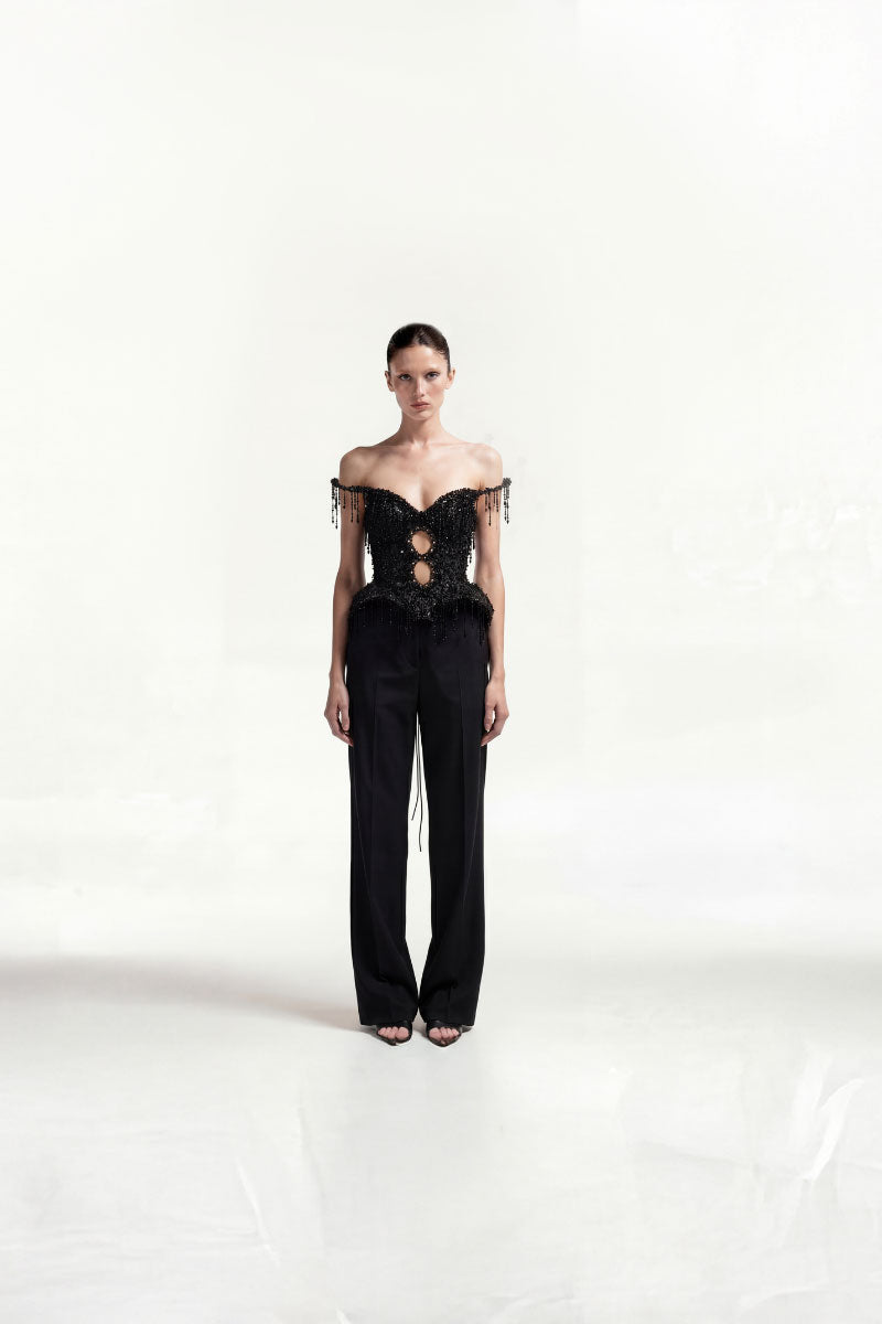 Black beaded fringe tweed corset top by Tayfun Kaba featuring intricate beaded details and a fitted, stylish design.