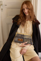 Sarah's Bag Bedouin Metallic Grace clutch with metallic finish, featuring intricate design and compact size for elegant carry.