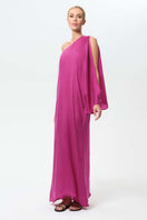 NiLuu Begonvil one-shoulder maxi dress featuring flowy fabric and elegant design, perfect for summer or special occasions.