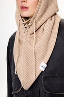 Beige LE SH KA balaclava hat made of soft fabric, covering the head and neck for warmth and style.